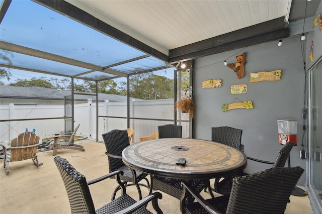 sunroom featuring beam ceiling