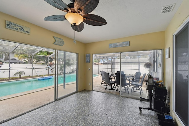 sunroom / solarium with a wealth of natural light and ceiling fan