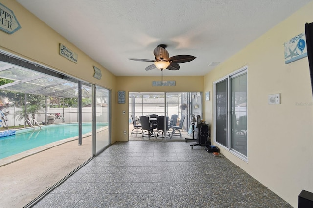 interior space featuring ceiling fan and a textured ceiling