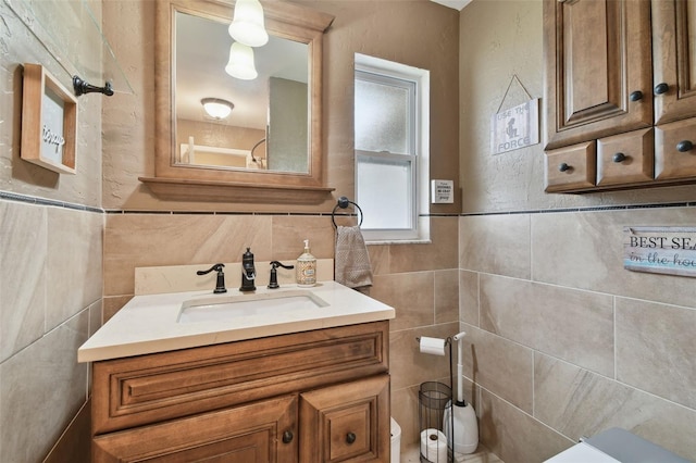 bathroom featuring tile walls and vanity