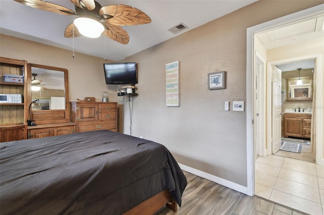 bedroom featuring sink and hardwood / wood-style flooring