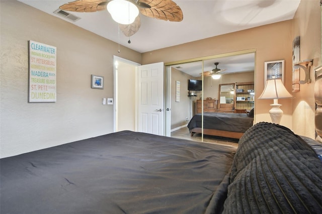 bedroom with hardwood / wood-style floors, ceiling fan, and a closet