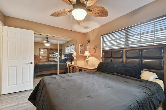 bedroom featuring ceiling fan, a closet, and light wood-type flooring