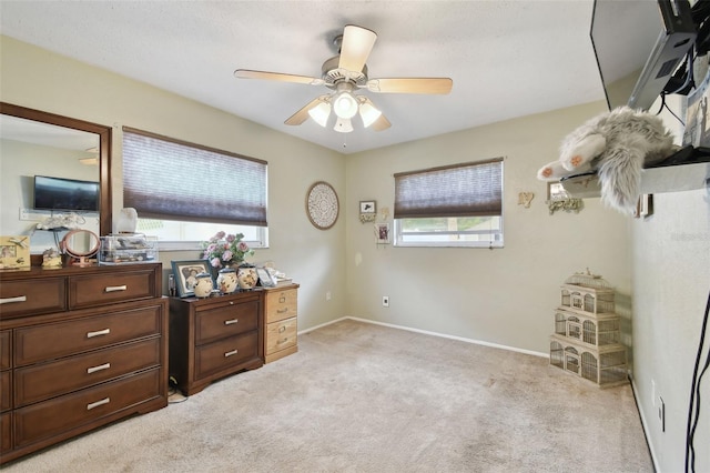 bedroom featuring ceiling fan and light carpet