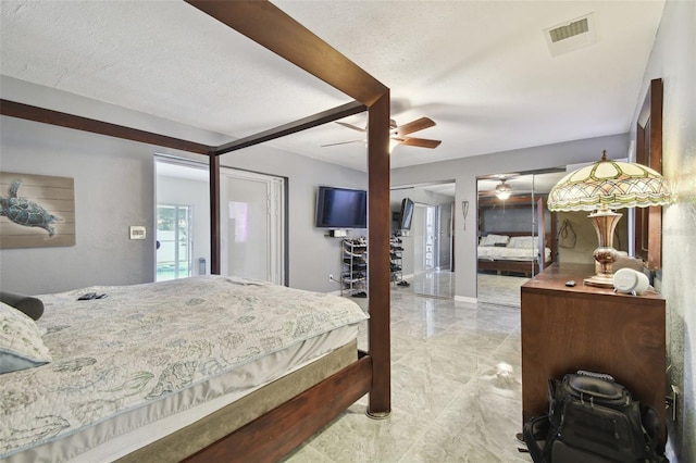 bedroom featuring ceiling fan and a textured ceiling