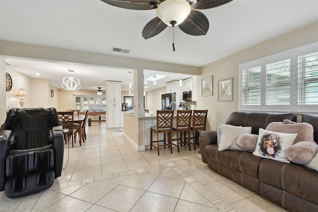 tiled living room featuring ceiling fan