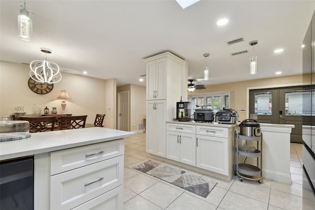 kitchen featuring wine cooler, white cabinetry, decorative light fixtures, light tile patterned floors, and ceiling fan