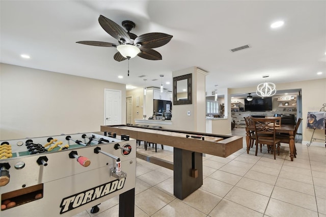 rec room with light tile patterned flooring and ceiling fan