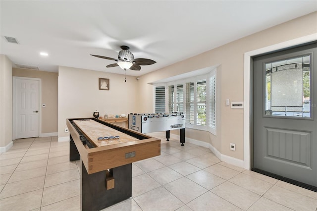 game room with ceiling fan and light tile patterned floors