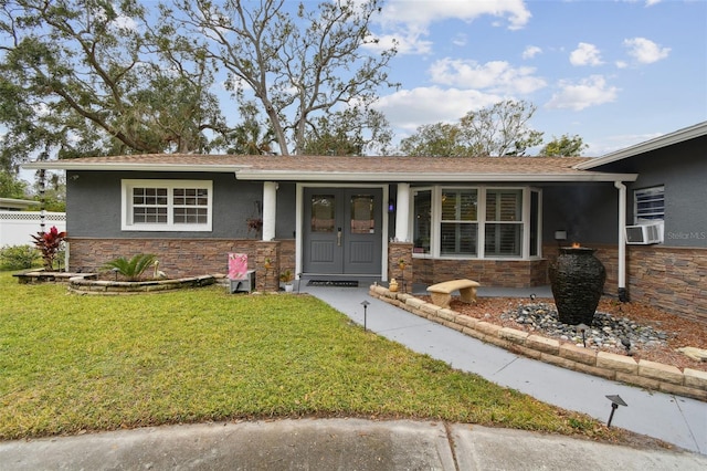 view of front of property with cooling unit, a front lawn, and covered porch