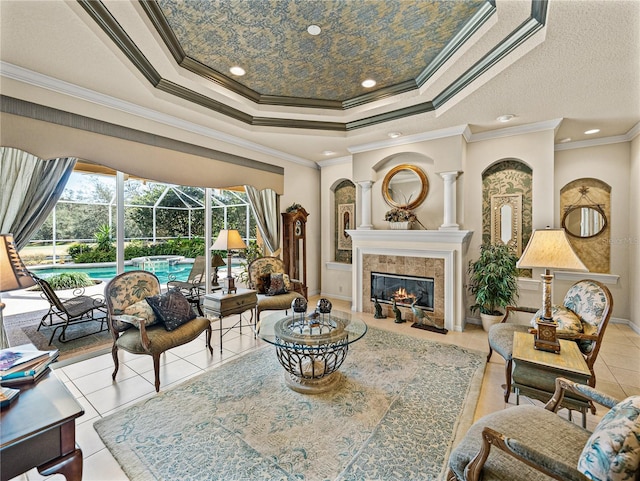 interior space featuring baseboards, a raised ceiling, a tile fireplace, a sunroom, and crown molding