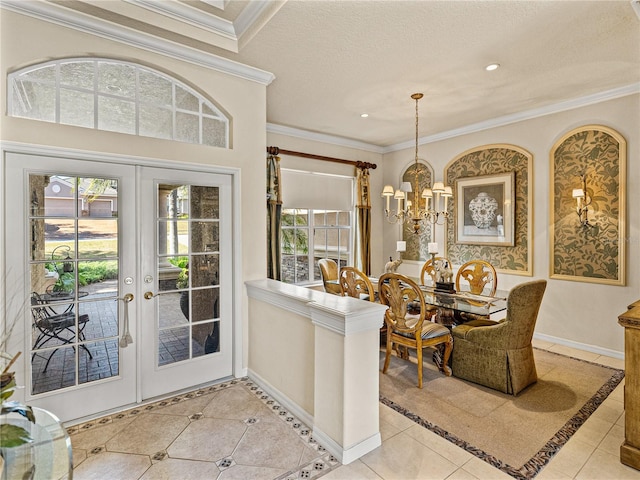 dining area featuring a chandelier, light tile patterned flooring, baseboards, french doors, and crown molding