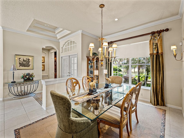 dining area with ornamental molding, french doors, light tile patterned flooring, and a raised ceiling