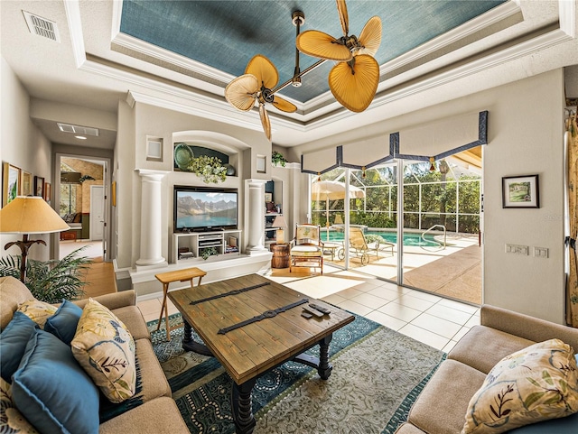 living room with a sunroom, tile patterned flooring, visible vents, and a raised ceiling