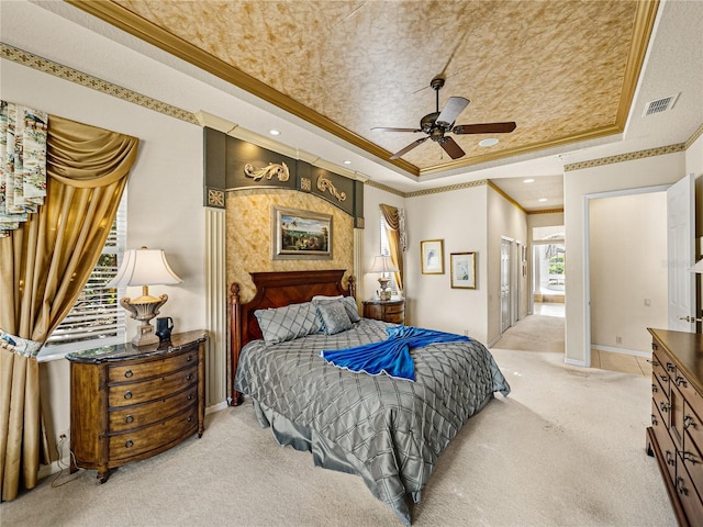 carpeted bedroom with visible vents, baseboards, ornamental molding, a tray ceiling, and recessed lighting