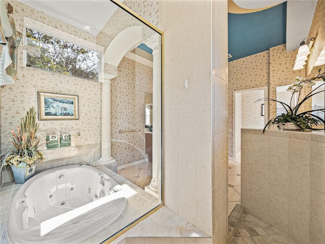 full bathroom featuring a tub with jets, tiled shower, and wallpapered walls