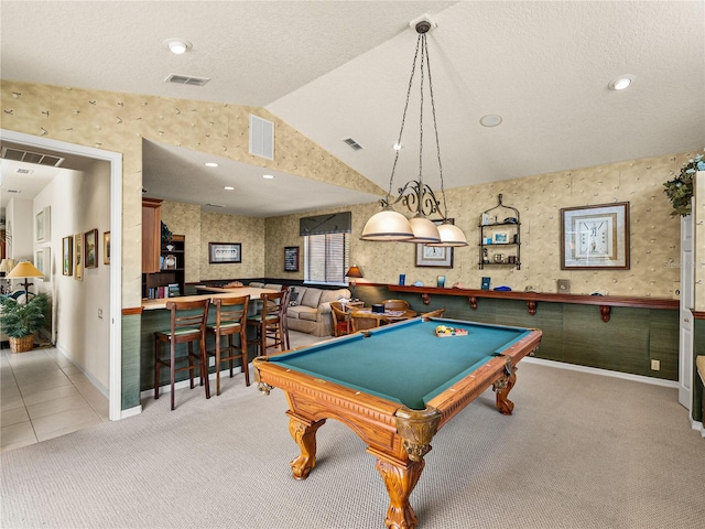 recreation room featuring lofted ceiling, wallpapered walls, visible vents, and carpet floors