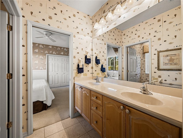 full bath featuring ensuite bathroom, wainscoting, a sink, and wallpapered walls