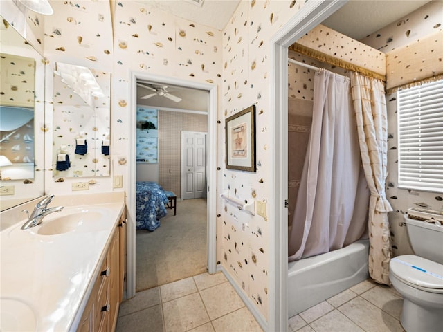 ensuite bathroom featuring tile patterned flooring, toilet, a sink, double vanity, and wallpapered walls