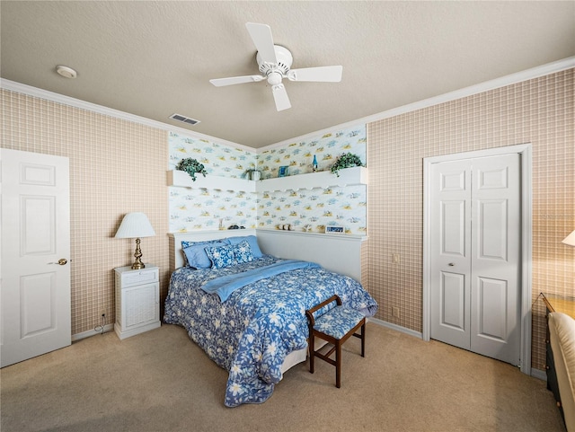 carpeted bedroom featuring a textured ceiling, ornamental molding, visible vents, and wallpapered walls