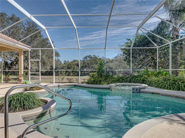 view of pool with a lanai, a pool with connected hot tub, and a patio