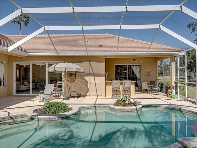 outdoor pool featuring a patio, glass enclosure, outdoor dining area, and a ceiling fan