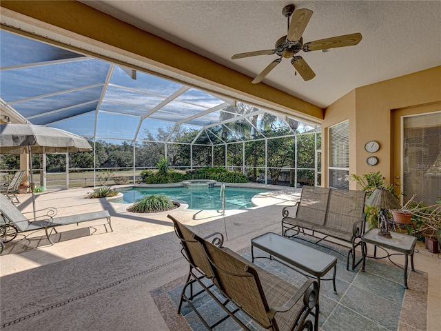 view of swimming pool with a lanai, ceiling fan, a pool with connected hot tub, and a patio