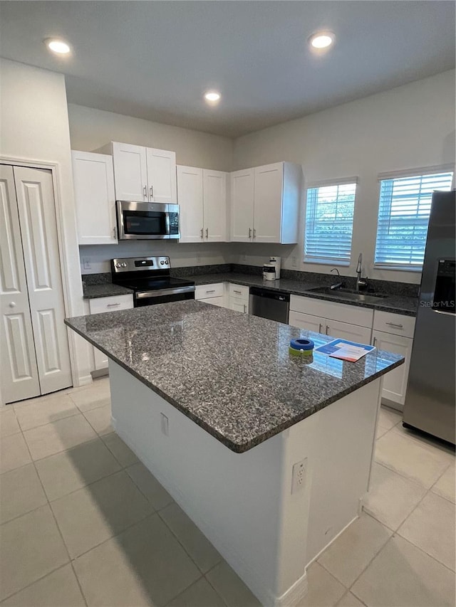 kitchen featuring dark stone countertops, sink, white cabinets, and appliances with stainless steel finishes