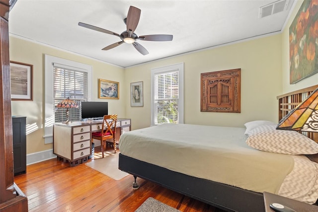 bedroom featuring crown molding, hardwood / wood-style floors, and ceiling fan