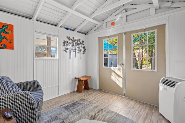 interior space featuring lofted ceiling with beams and light wood-type flooring