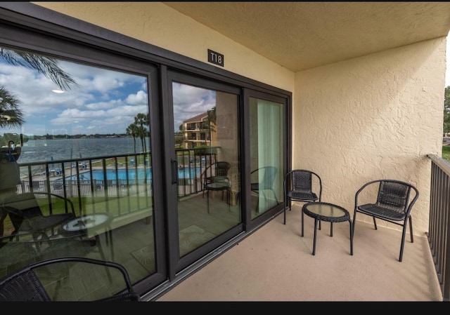 balcony featuring a water view