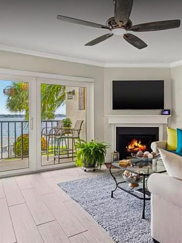 interior space with crown molding, wood-type flooring, and ceiling fan