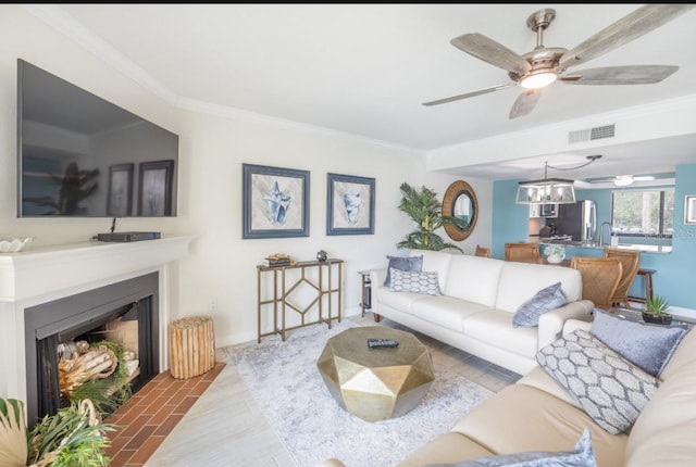 living room featuring crown molding, ceiling fan, and hardwood / wood-style flooring