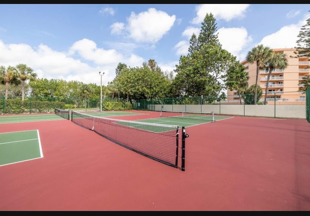 view of tennis court with basketball hoop