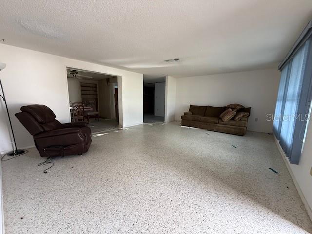 living room with a textured ceiling