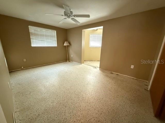 unfurnished room with ceiling fan