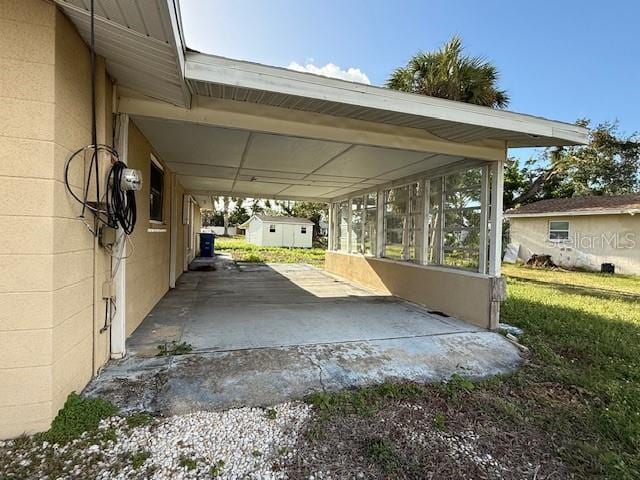 view of patio / terrace featuring a carport and a storage shed