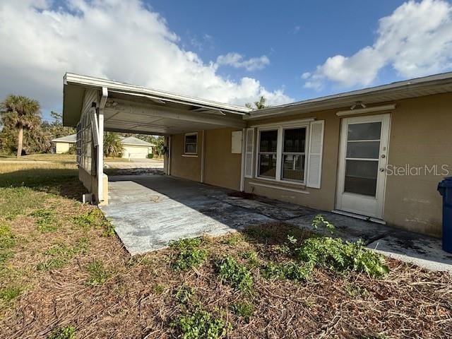 exterior space with a carport