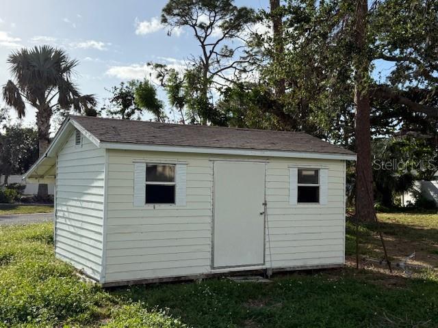 view of outbuilding featuring a yard