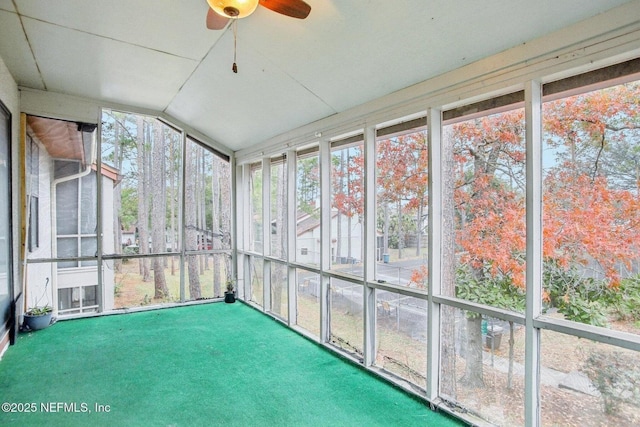 unfurnished sunroom featuring ceiling fan and vaulted ceiling