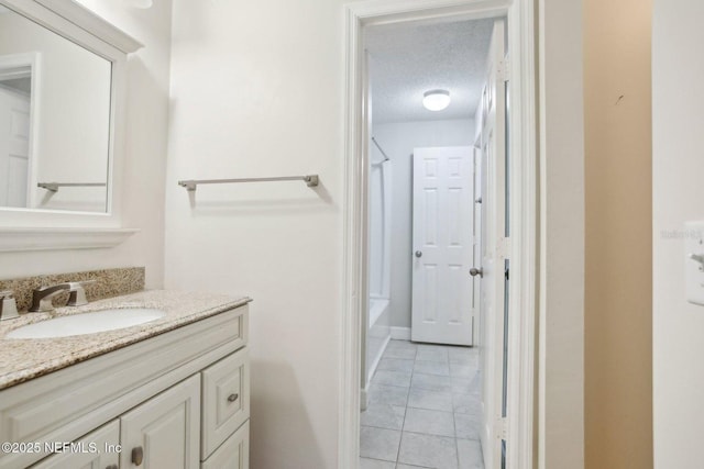 bathroom with vanity, tile patterned flooring, and a textured ceiling