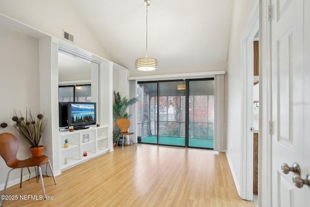 living room featuring wood-type flooring and lofted ceiling