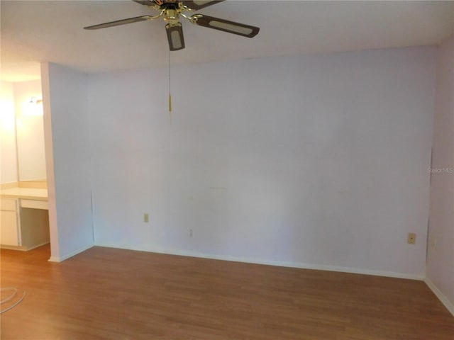 unfurnished room with wood-type flooring and ceiling fan