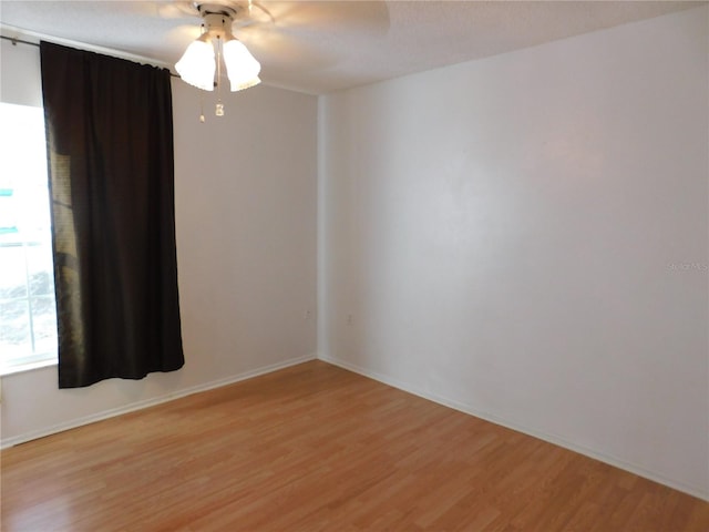 empty room with ceiling fan and light wood-type flooring