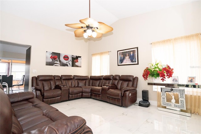 living room with ceiling fan and vaulted ceiling