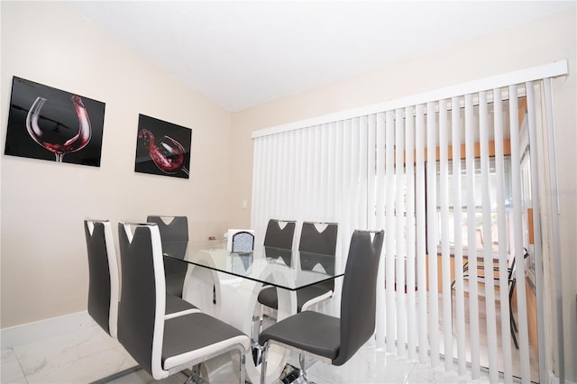 dining room featuring lofted ceiling