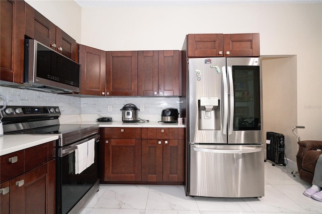 kitchen with tasteful backsplash and appliances with stainless steel finishes