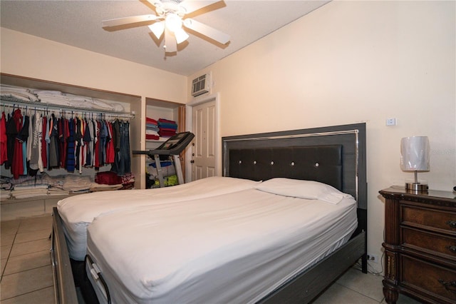 tiled bedroom featuring ceiling fan and a closet