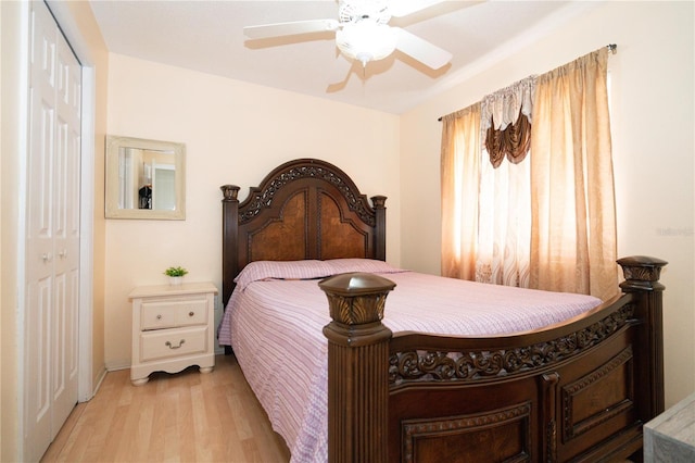 bedroom with ceiling fan, a closet, and light hardwood / wood-style flooring