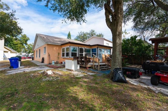 back of property featuring a sunroom